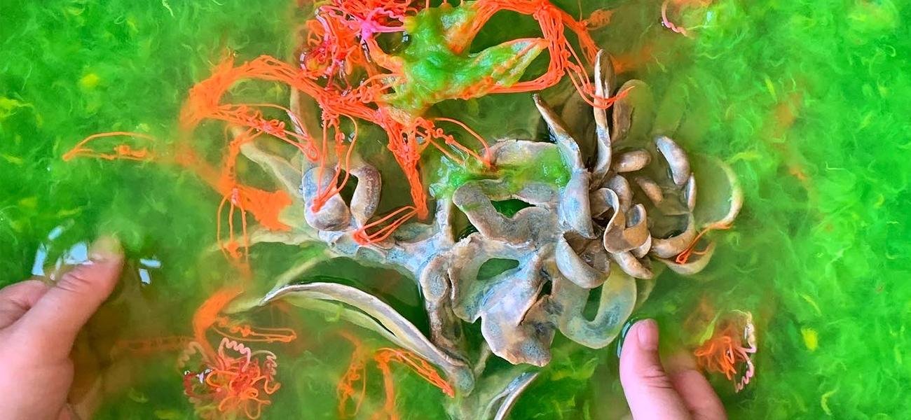Ceramic and 3-d pen structure being dragged through pigmented kozo (paper mulberry) fiber for State Changes installation