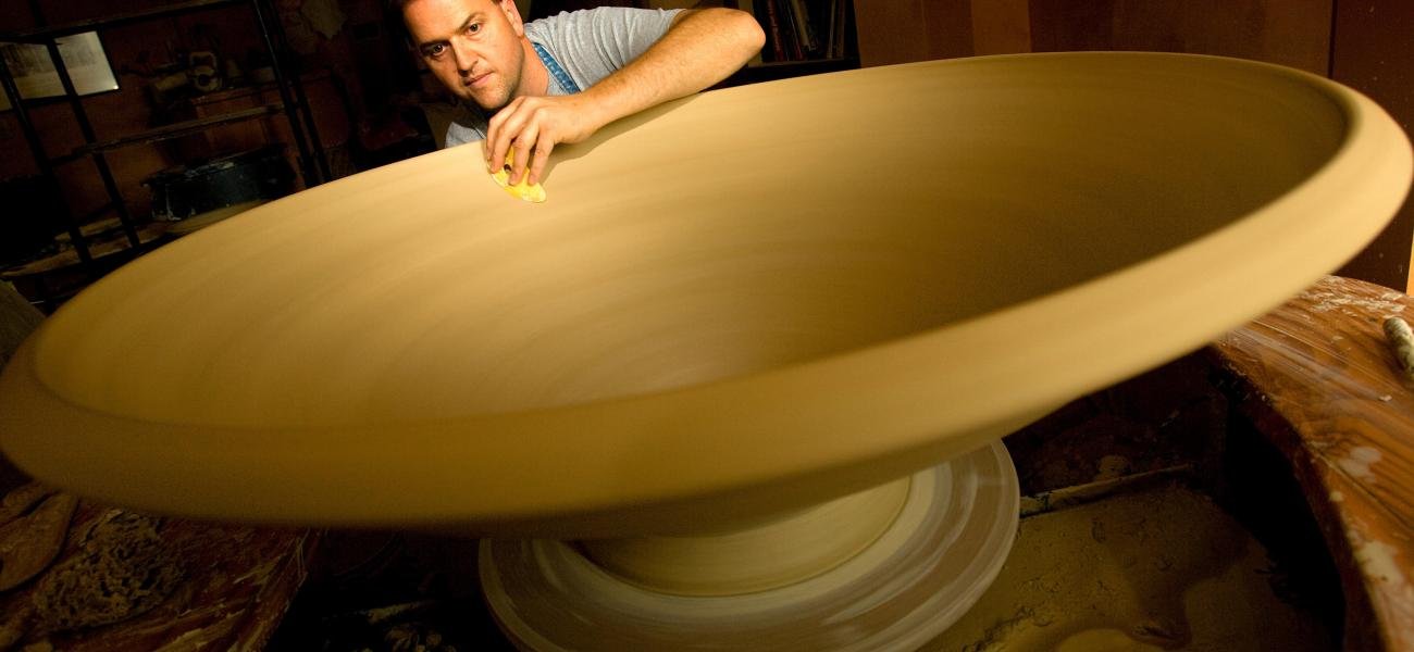 Ben making a large bowl for an installation, 2008. 16x48x48 in. Photograph by Jerry Wolford