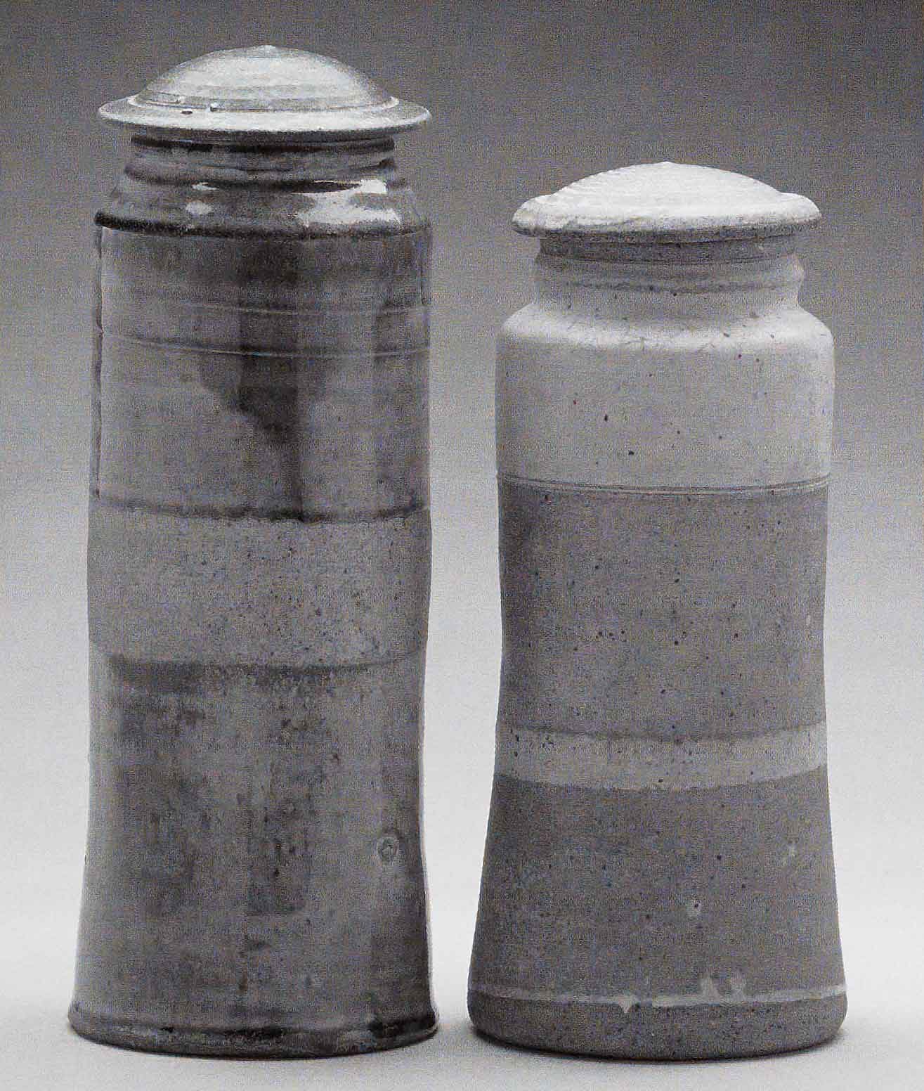 Heirloom Jars (Left) November 2003. Cone 11 woodfired stoneware, ash glaze over porcelain slip. H 12" x W 5". (Right) March 1972, bisqued, Cone 10 gas reduction stoneware, spodumene glaze. H 10.25" x W 5". Photograph by VanZandenbergen. Heirloom Jars (Left) November 2003. Cone 11 woodfired stoneware, ash glaze over porcelain slip. H 12" x W 5". (Right) March 1972, bisqued, Cone 10 gas reduction stoneware, spodumene glaze. H 10.25" x W 5". Photograph by VanZandenbergen.