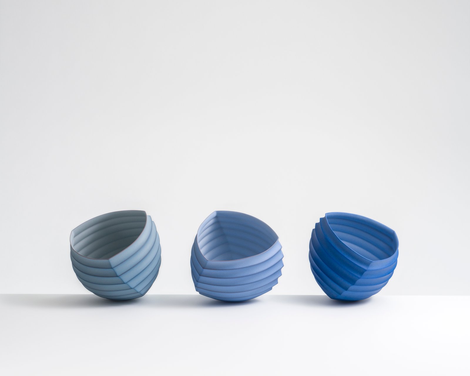 Mark Goudy, Origami Objects (#1330, #1306, #1299), slip-cast unglazed porcelain + soluble metal salts (gold, cobalt, chromium).