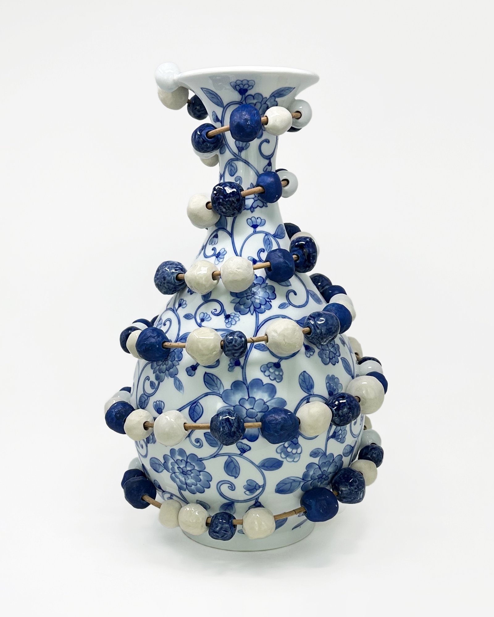 Abacus Vase, 2025. Porcelain, rattan. Image courtesy of the artist. Micah Lewis-Văn Sweezie, Abacus Vase, 2025. Porcelain, rattan. Image courtesy of the artist.
