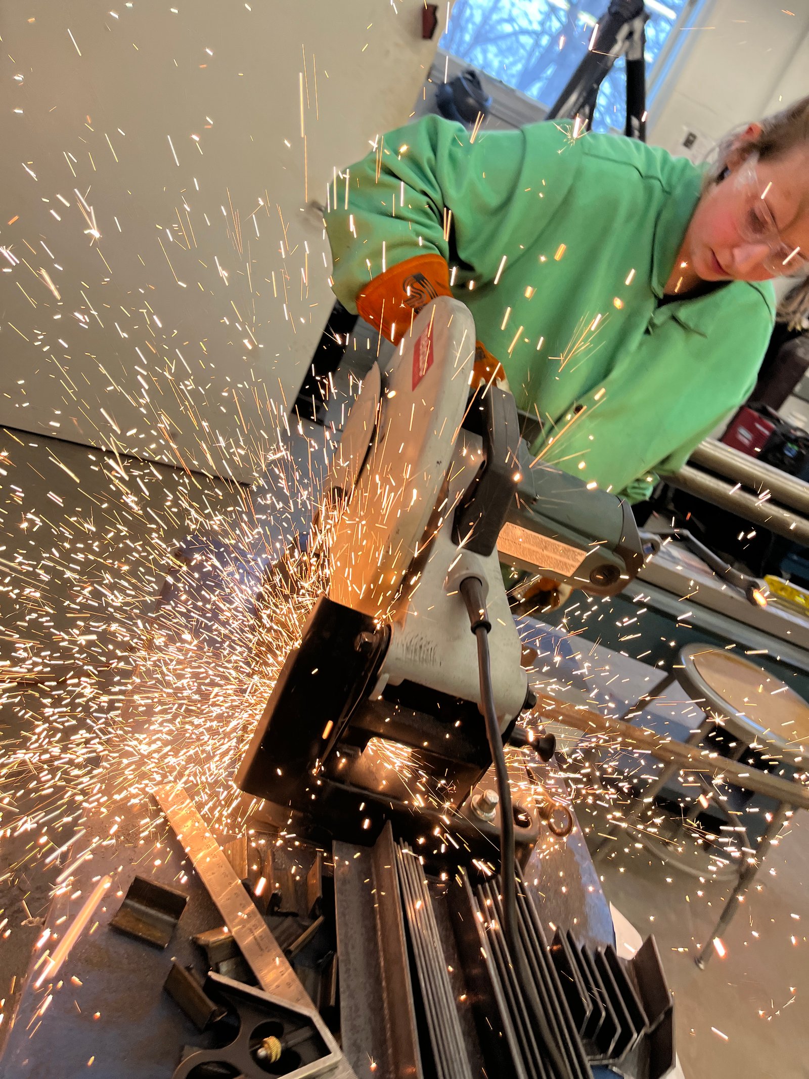 Student cutting steel.